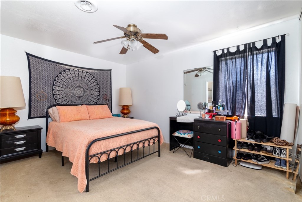 41320 Linda Vista Court Hemet, CA 92544 - Photo 19 of 31 a bedroom with a bed closet and flat tv screen