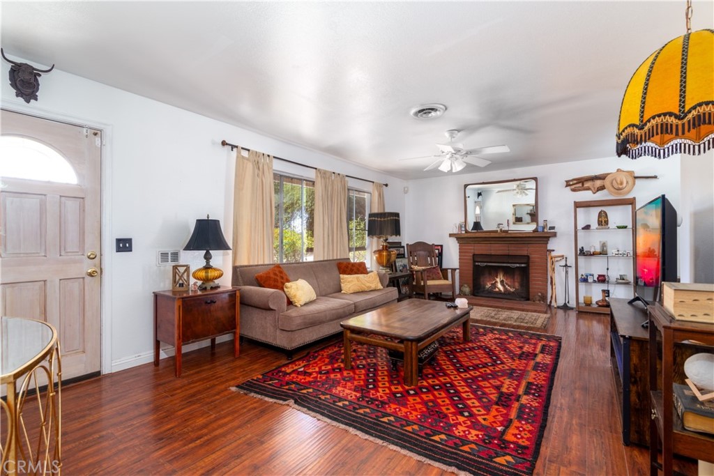 41320 Linda Vista Court Hemet, CA 92544 - Photo 5 of 31 a living room with furniture and a fireplace