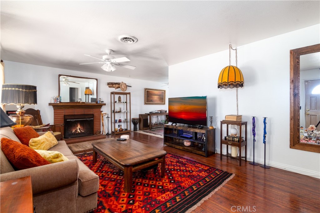 41320 Linda Vista Court Hemet, CA 92544 - Photo 6 of 31 a living room with furniture a flat screen tv and a fireplace