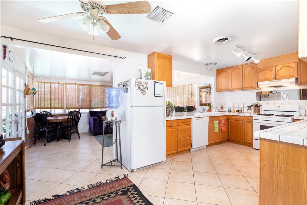 41320 Linda Vista Court Hemet, CA 92544 - Photo 9 of 31 a kitchen with refrigerator cabinets and stove