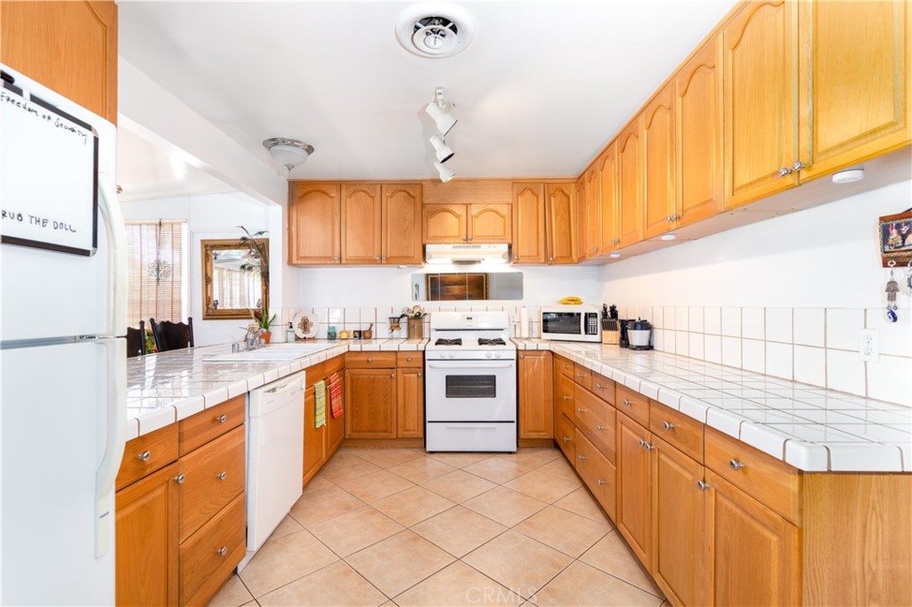 41320 Linda Vista Court Hemet, CA 92544 - Photo 10 of 31 a kitchen with stainless steel appliances granite countertop a sink and cabinets