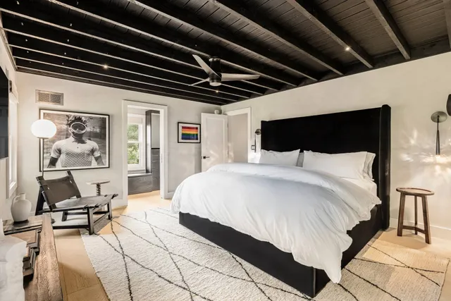 a bedroom with a bed a table and chair