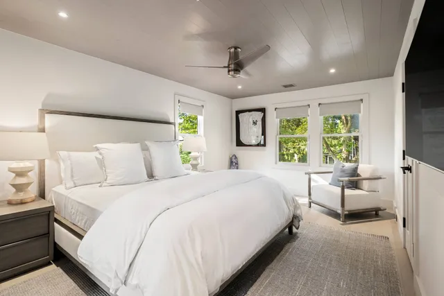 a bedroom with a large bed and a large window