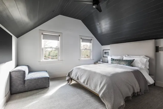 a spacious bedroom with a bed and a couch