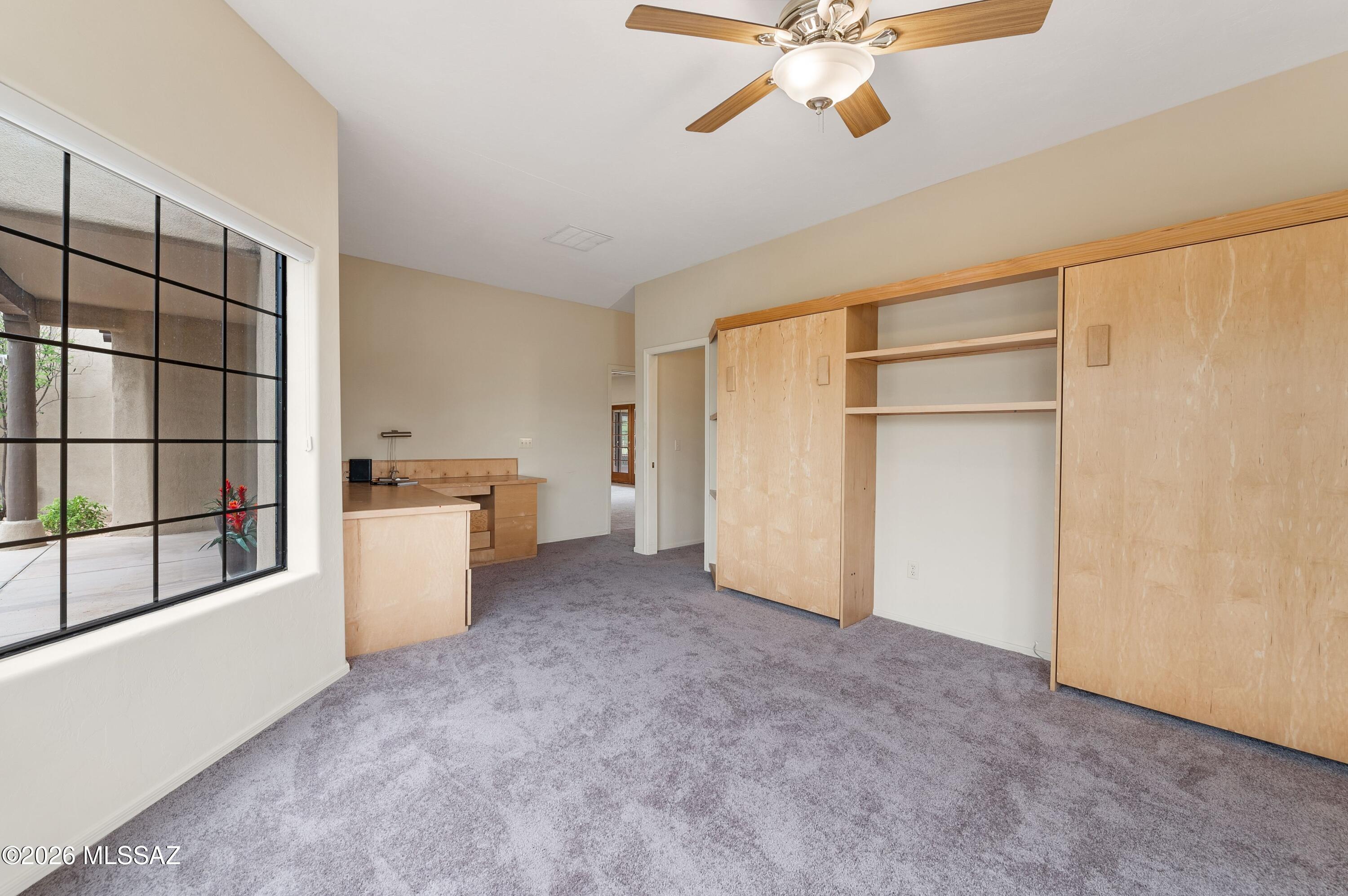 12160 East Tanque Verde Road Tucson, AZ 85749 - Photo 16 of 53 Built-in wood murphy beds, bay window, and ceiling fan.