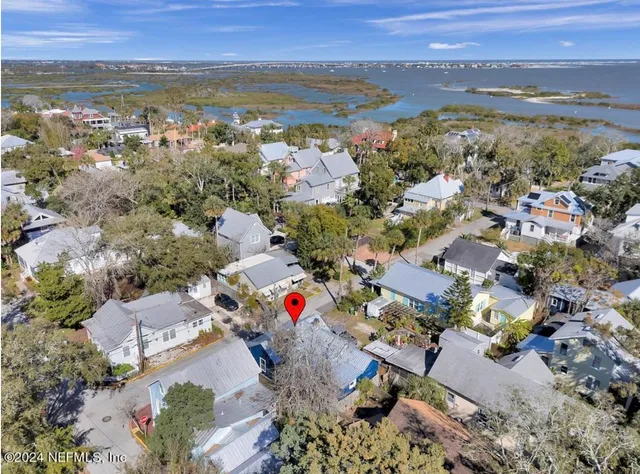 an aerial view of residential houses with outdoor space