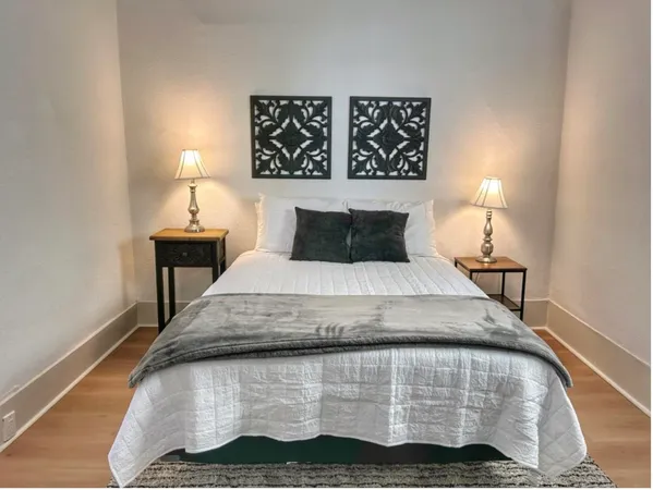 a bedroom with a bed and a night stand