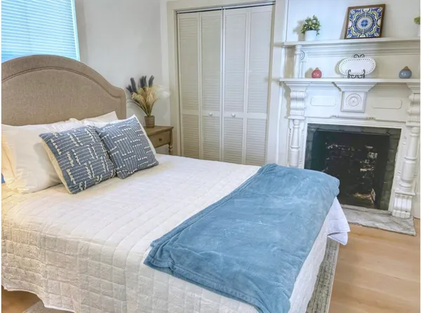 a bedroom with a bed and a fireplace