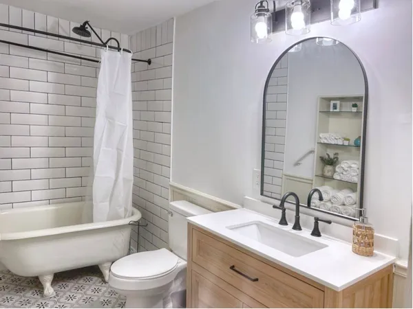 a bathroom with a sink toilet and shower