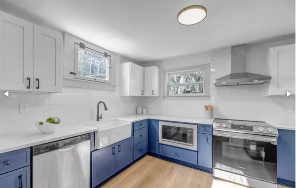 a kitchen with stainless steel appliances a sink stove and cabinets
