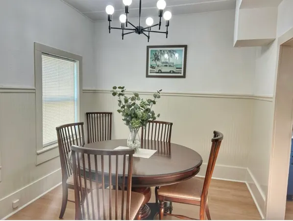a view of a dining room with furniture and chandelier