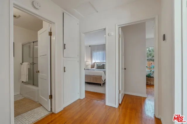 a bedroom with a bed and a mirror