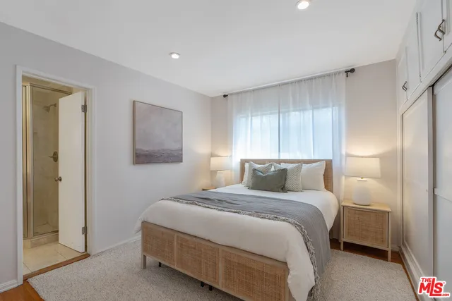 a bathroom with a shower a sink and a mirror