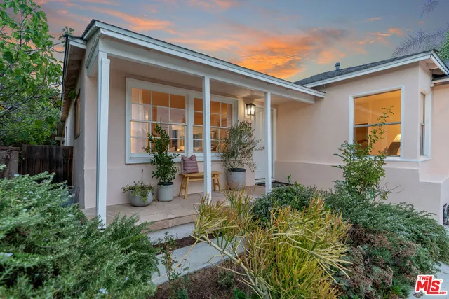 front view of a house with potted plants