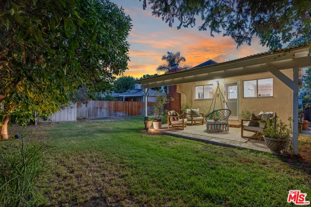a view of a house with backyard and porch