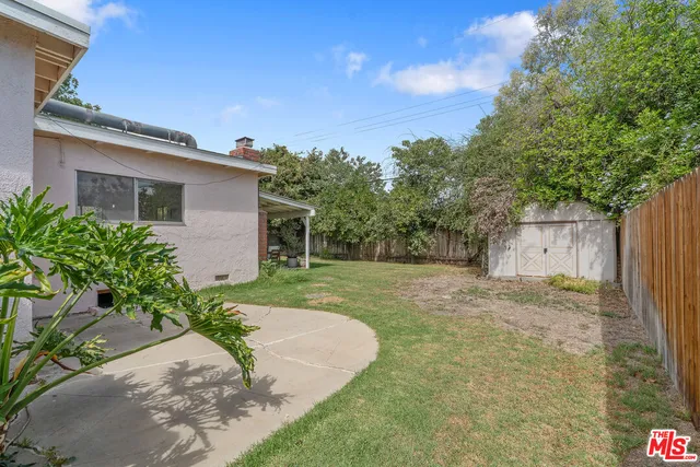 a view of house with backyard space and garden