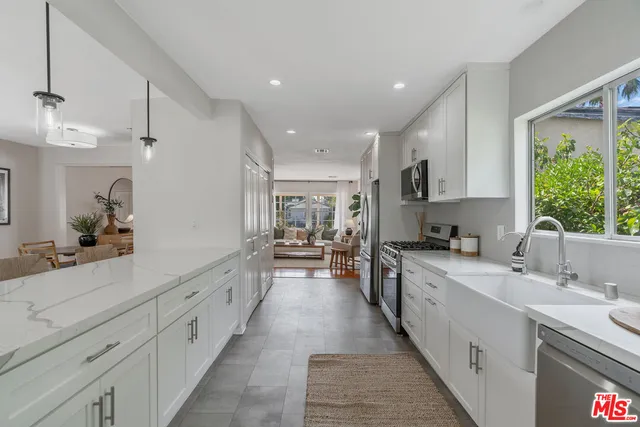 a large kitchen with stainless steel appliances lots of counter space sink and cabinets