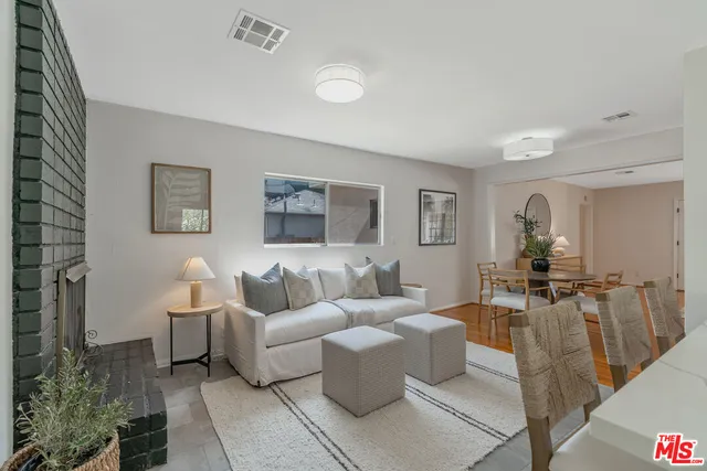 a kitchen with stainless steel appliances granite countertop a table and chairs