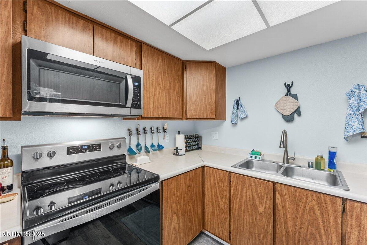 63 Vista Rafael Parkway Reno, NV 89503 - Photo 13 of 24 a kitchen with stainless steel appliances a stove a sink cabinets and a microwave