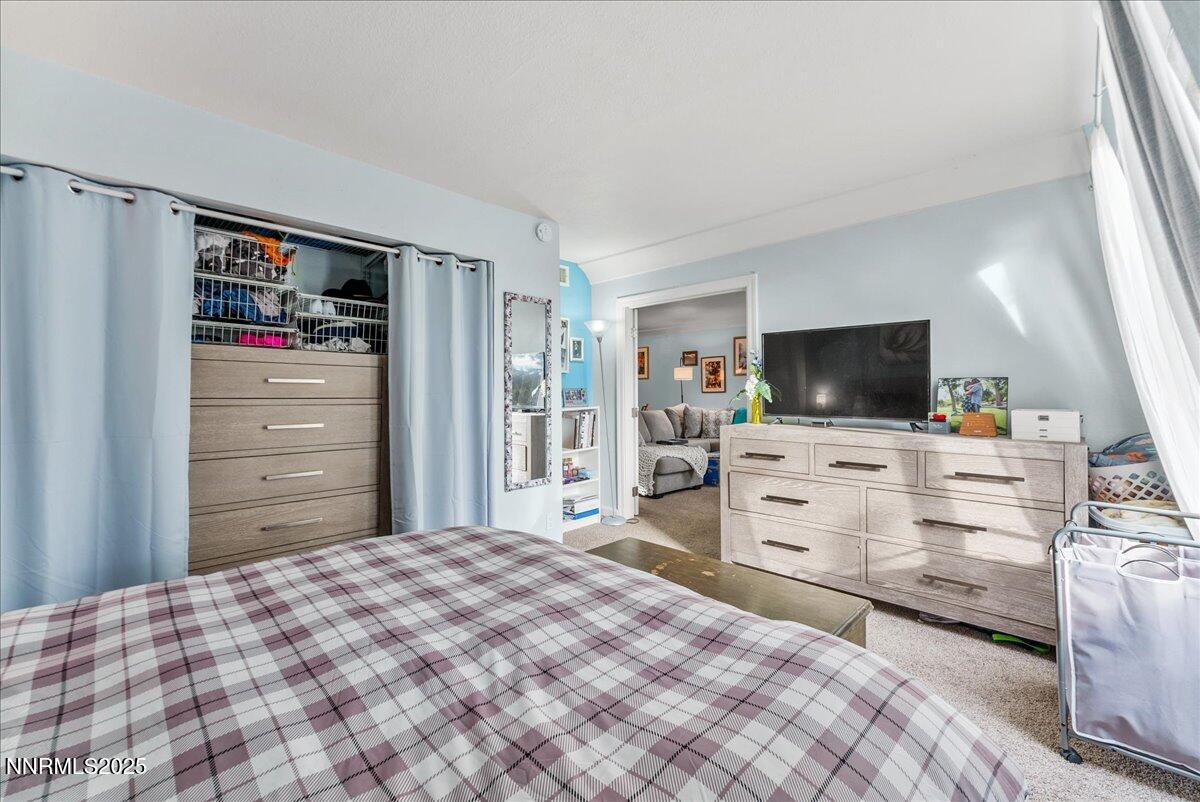 63 Vista Rafael Parkway Reno, NV 89503 - Photo 16 of 24 a bedroom with a bed and flat screen tv