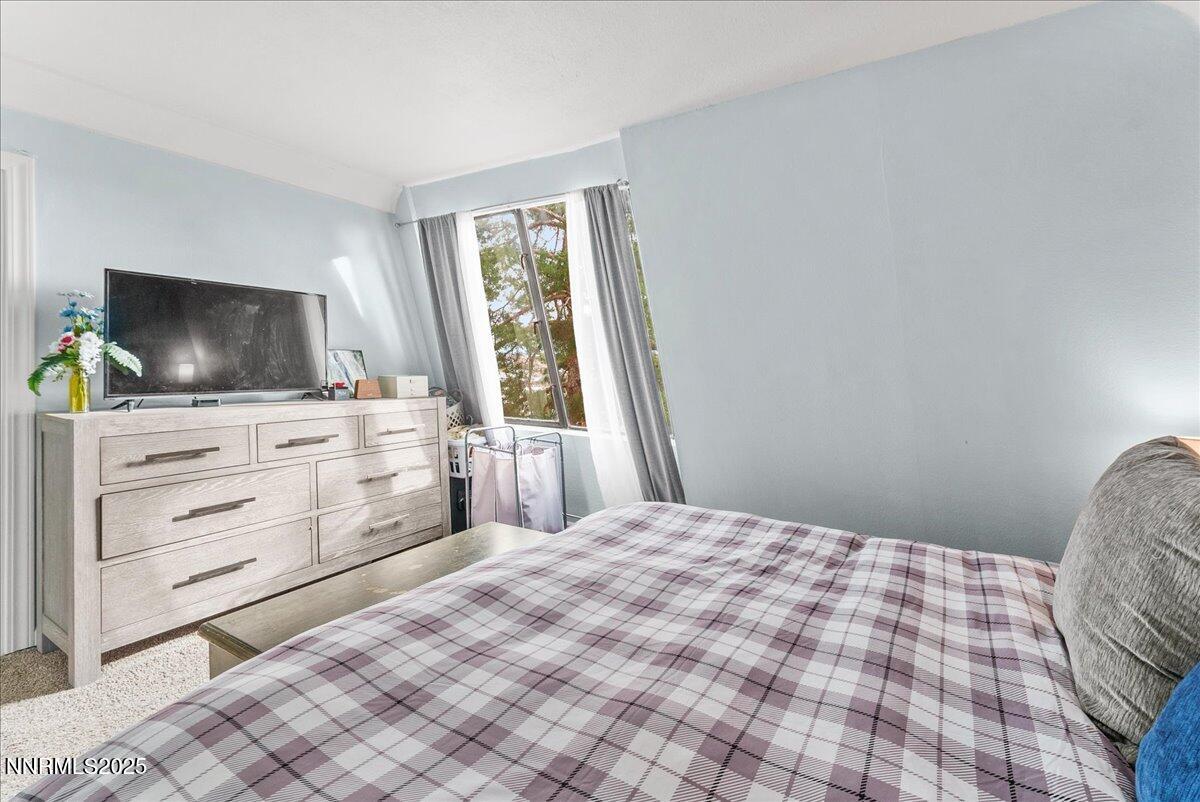 63 Vista Rafael Parkway Reno, NV 89503 - Photo 17 of 24 a bedroom with a bed and a flat screen tv