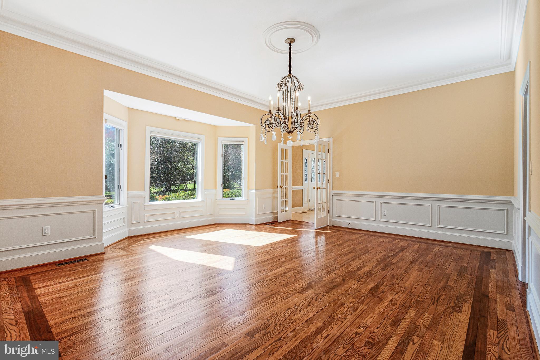 938 Douglass Drive McLean, VA 22101 - Photo 25 of 105 a view of an empty room with wooden floor and a window
