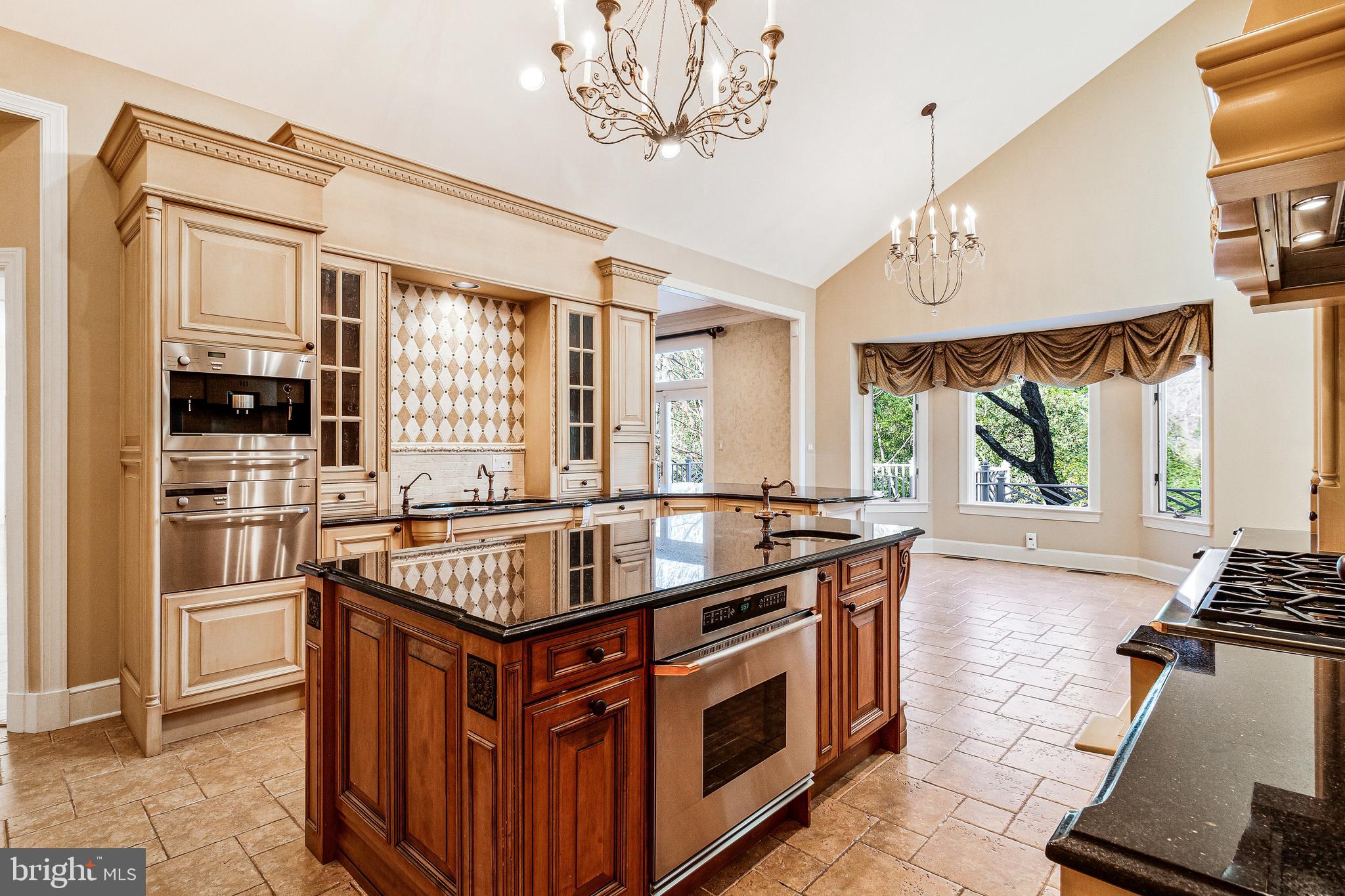 938 Douglass Drive McLean, VA 22101 - Photo 29 of 105 a kitchen with stainless steel appliances granite countertop a stove and a refrigerator