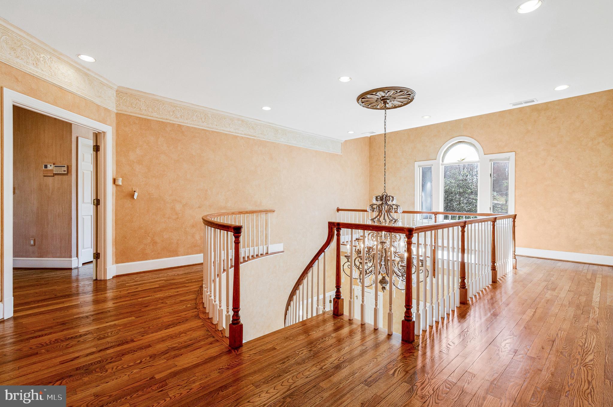 938 Douglass Drive McLean, VA 22101 - Photo 41 of 105 a view of a hallway with wooden floor and stairs