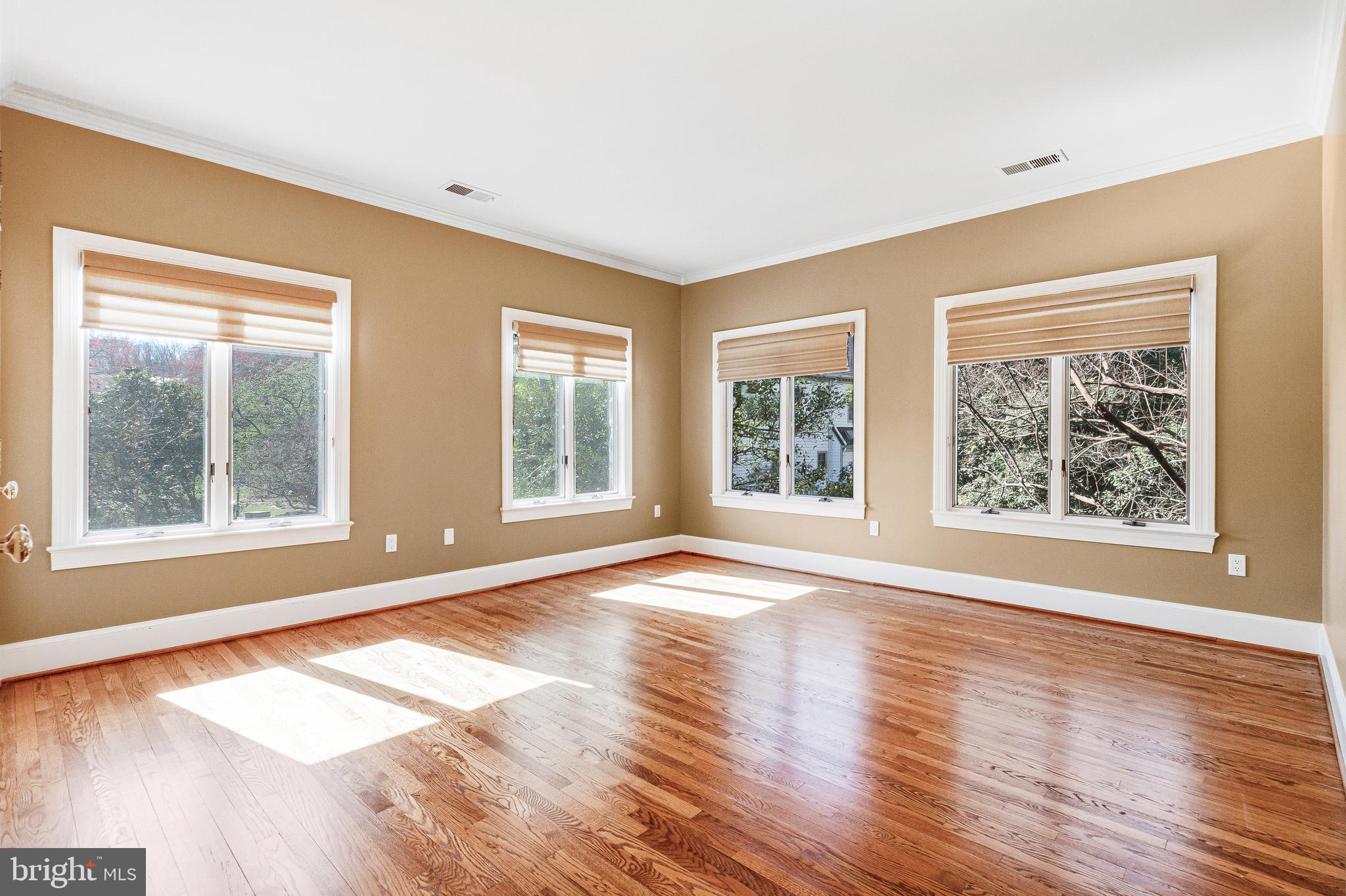 938 Douglass Drive McLean, VA 22101 - Photo 43 of 105 a view of an empty room with wooden floor and a window