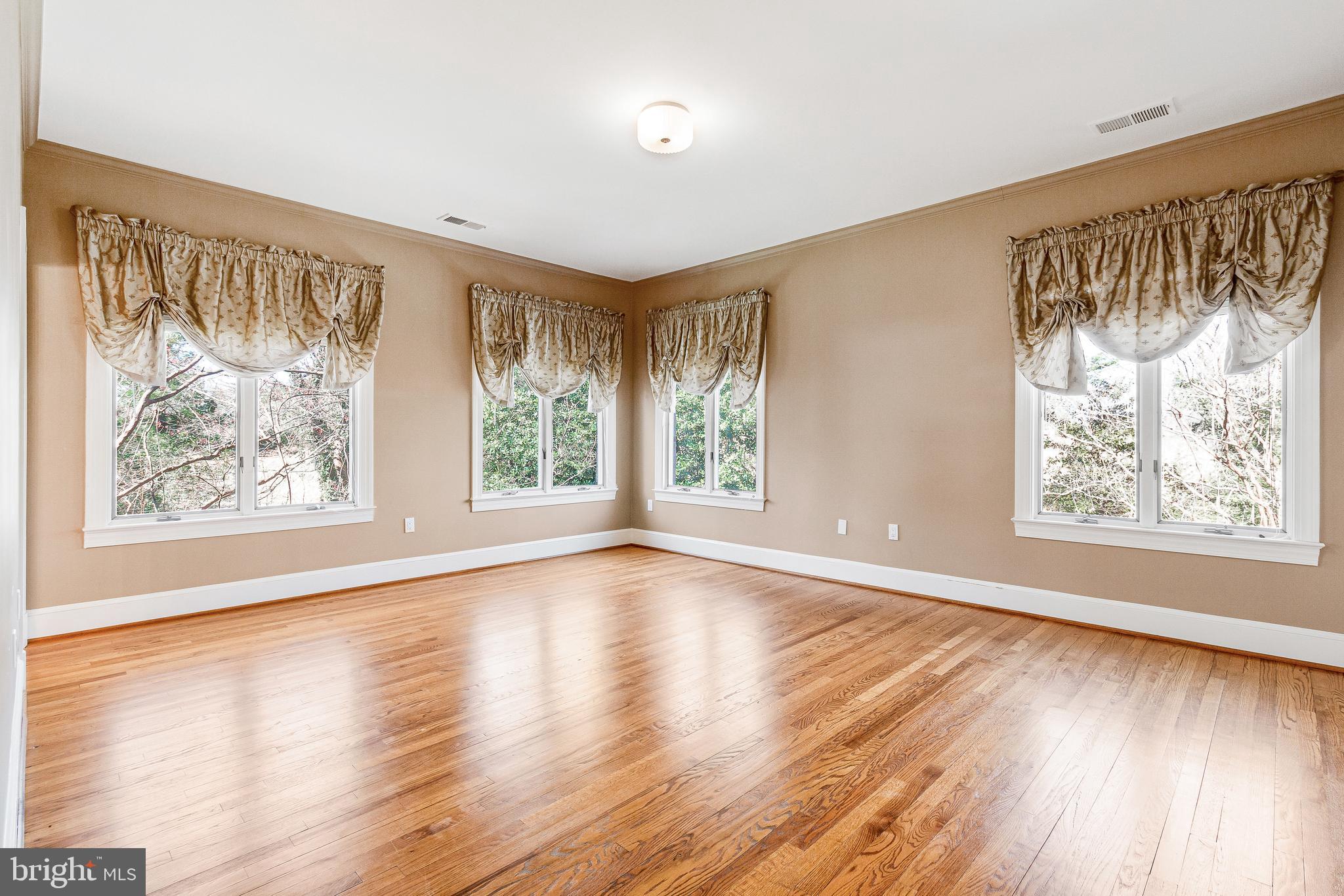 938 Douglass Drive McLean, VA 22101 - Photo 46 of 105 a view of an empty room with wooden floor and a window