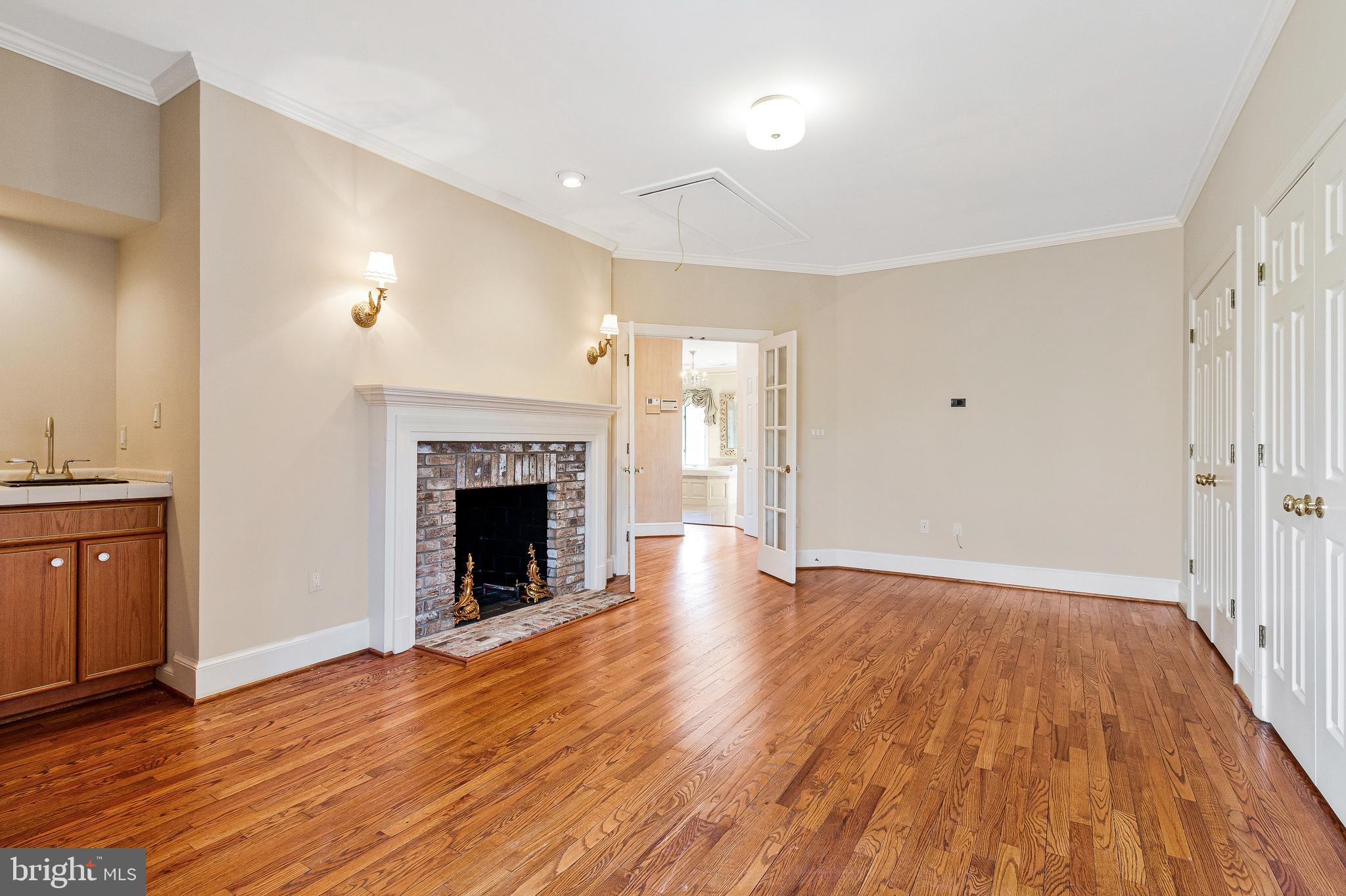 938 Douglass Drive McLean, VA 22101 - Photo 52 of 105 a view of an empty room with wooden floor fireplace and a window