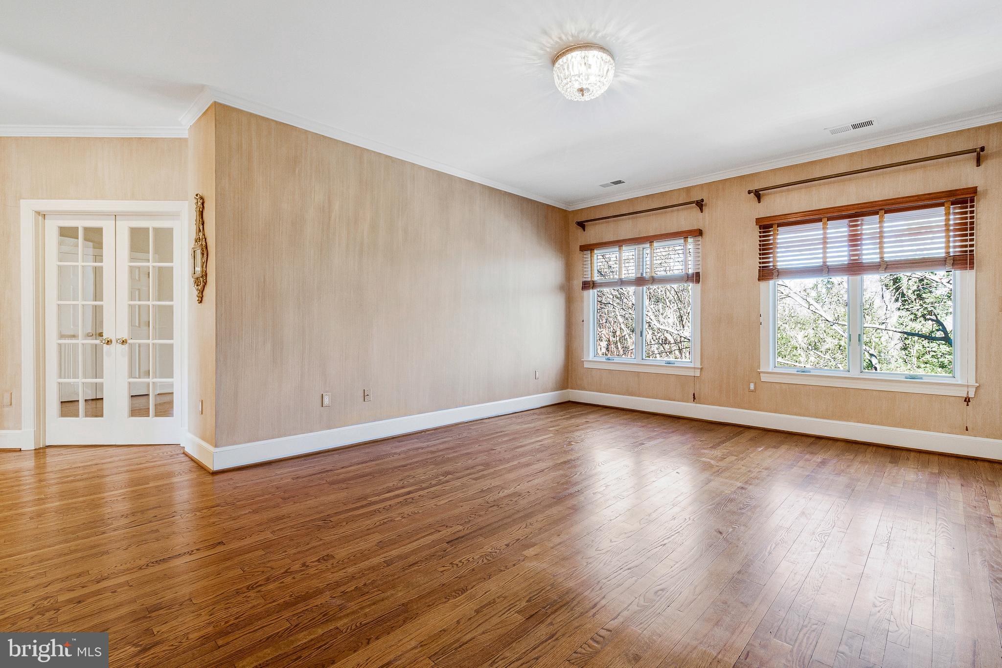 938 Douglass Drive McLean, VA 22101 - Photo 55 of 105 an empty room with wooden floor and windows