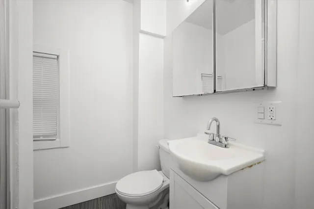 a bathroom with a sink a toilet and mirror