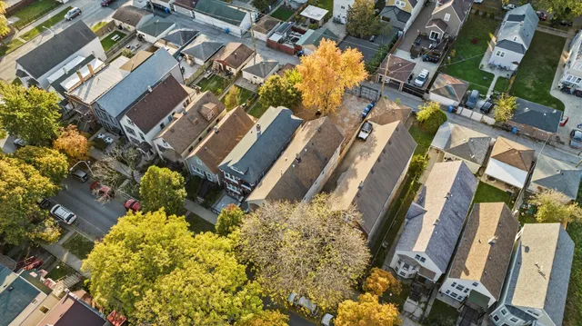 an aerial view of a house with a yard and a fountain