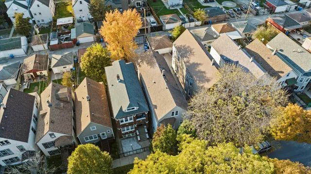 an aerial view of a house with a yard