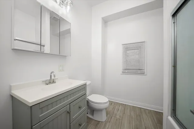 a bathroom with a sink toilet and vanity