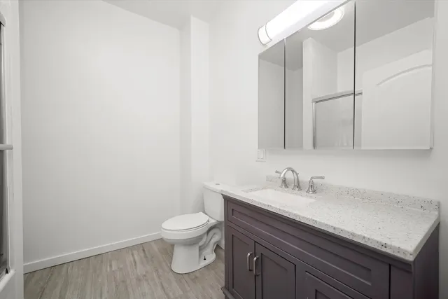 a bathroom with a sink toilet and vanity