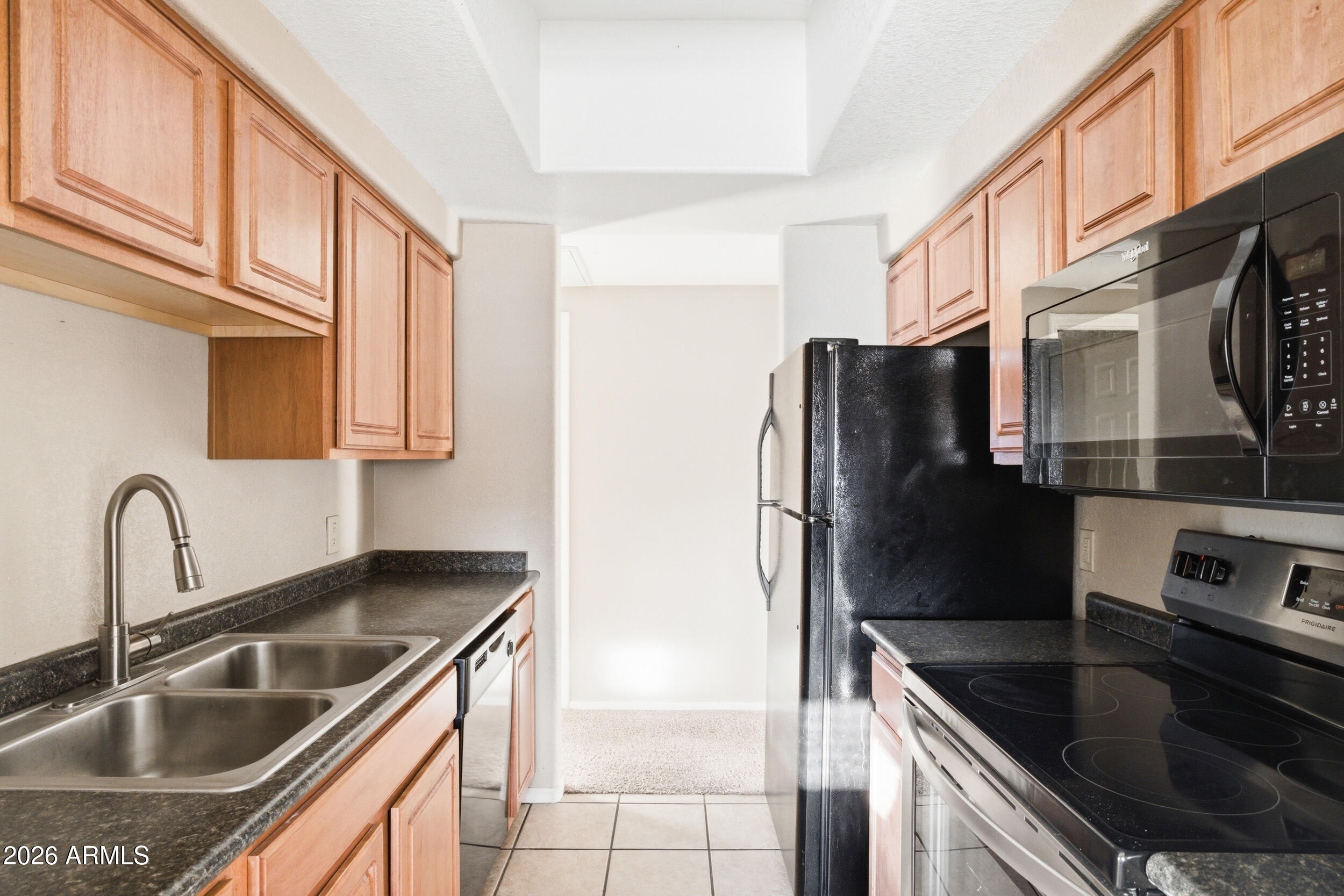 3434 East Baseline Road, Unit 264 Phoenix, AZ 85042 - Photo 6 of 12 a kitchen with granite countertop a refrigerator and a sink