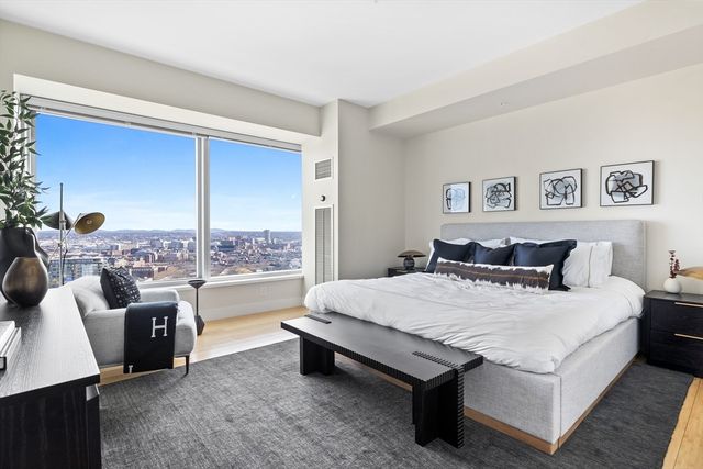 a large bed sitting in a bedroom and a table