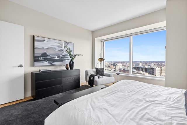 a bedroom with a bed and a large window