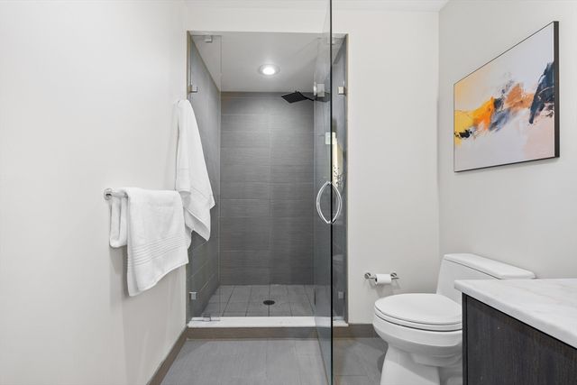 a bathroom with a shower and a toilet