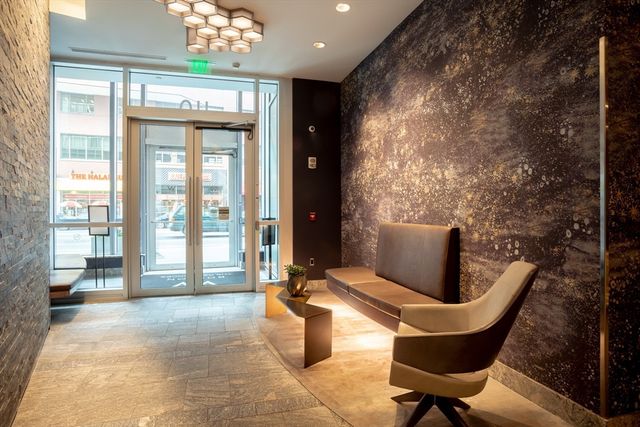 a lobby with furniture and floor to ceiling window