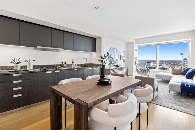 a view of a kitchen area with furniture and wooden floor