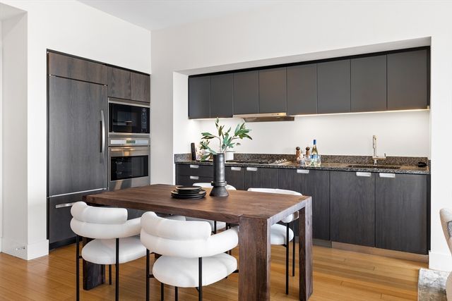 a kitchen with a table chairs and microwave