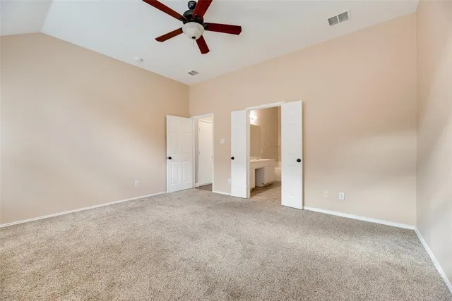 an empty room with a ceiling fan