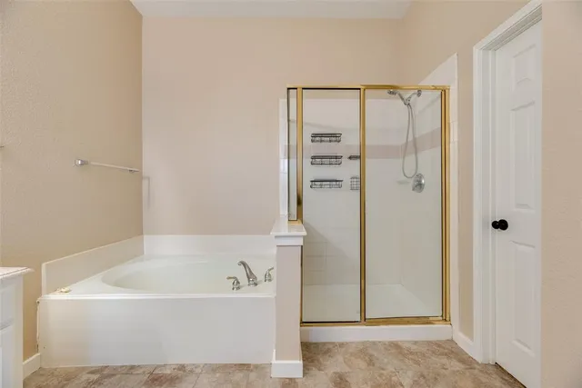 a bathroom with a bathtub and a shower