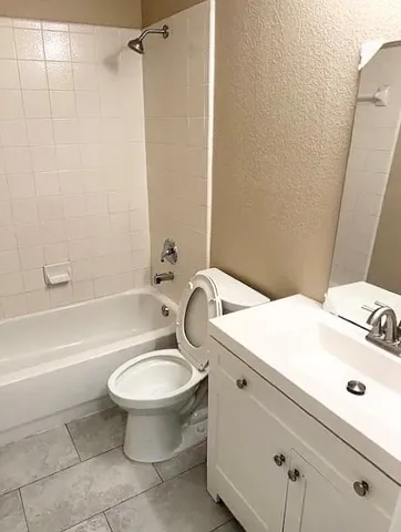 a bathroom with a sink a toilet and a bathtub