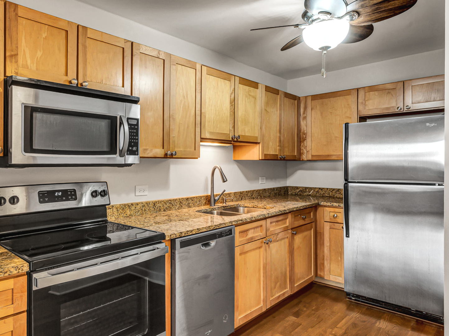 5320 North Sheridan Road, Unit 2002 Chicago, IL 60640 - Photo 19 of 57 a kitchen with stainless steel appliances granite countertop a stove microwave refrigerator and sink
