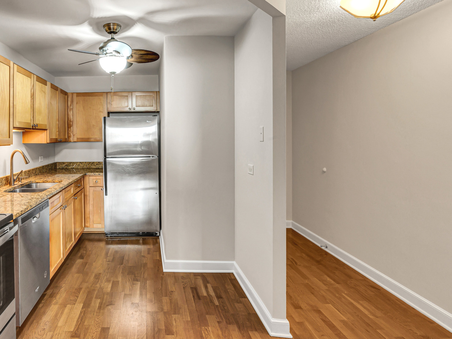 5320 North Sheridan Road, Unit 2002 Chicago, IL 60640 - Photo 20 of 57 a kitchen with kitchen island wooden floor center island and stainless steel appliances