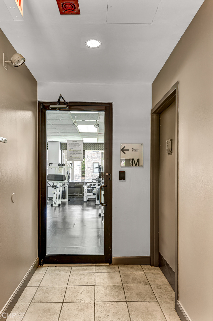 5320 North Sheridan Road, Unit 2002 Chicago, IL 60640 - Photo 49 of 57 a view of a hallway with wooden shelves